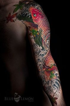 a man's arm with tattoos on it and an image of a fish in the water