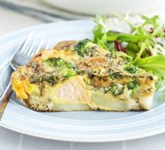 a piece of quiche with broccoli and salad on a plate next to a fork