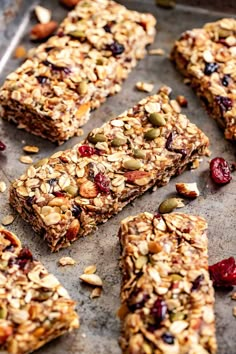 granola bars with nuts and dried cranberries on a baking sheet, ready to be eaten