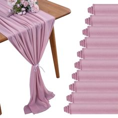 the table is covered with pink cloths and flowers