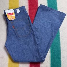 Levi's 946 High Waisted Bell Bottom Jeans From 1975 Brand - Levi's Content - 50% Dacron Polyester 50% Cotton Size - Labeled Husky 33 Waist - 16.5" Across Measured Flat, 16.75" Pulled Taut Hips - Approx 19" Across Rise - 12" Inseam - 29" Outseam - 40" Thigh - 11.75" Across Leg Opening - 10.75" Across Condition - Brand New With Tags Levi's Wide Leg Blue Pants, Retro Blue Bottoms For Fall, Retro Levi's Bottoms With Pockets, Fitted Vintage Denim Blue Pants, Vintage Fitted Blue Jeans, Retro Levi's Blue Bottoms, Fitted Blue 1970s Style Bottoms, Vintage Fitted Blue Bottoms, Fitted 1970s Style Blue Bottoms