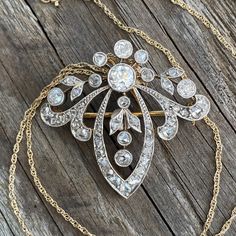 "Details: Edwardian Belle Époque diamond pendant from the early 1900's. There is a count of 50 diamonds, the largest being 5mm close to 1/2 carat. There are 5 large bezel set Old European Cut diamonds and the balance are bead set and bezel set rose cut diamonds. Mille grain work on all edges is meticulously finished. The center five diamonds move independently of the surround. A very pretty piece in excellent condition. The gold pendant tests at 18K and the 16\" modern chain is 14K gold. The pin Victorian Diamond Filigree Brooches, Classic Diamond Brilliant Cut Brooch, Classic Diamond Brooch With Brilliant Cut, Antique Rose Cut Diamonds Jewelry For Vintage Events, Luxury Diamond Brooch With Rose Cut Diamonds, Classic Diamond Brooches With Brilliant Cut, Fine Jewelry Diamond Brooches With Single Cut Diamonds, Antique White Gold Diamond Necklace, Victorian Diamond Necklace With Single Cut Diamonds For Formal