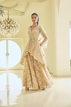 This high-low jacket sharara set features ivory thread, sequin, and pearl embroidery. The full-sleeved top shows pearl detail along the neckline, wrist, and at the hem of the Sharara top. It is paired with a fully embroidered dupatta.From Seema Gujral's Fiori - the sharara edit collection. DELIVERY TIME Please allow 8-12 weeks for your outfit to arrive. FABRIC DETAILSNet Professional cleaning only. Sharara Top, Jacket Sharara, Full Sleeves Top, Dotti Dresses, Eid Clothes, Seema Gujral, Desi Vibes, Sharara Designs, Nikah Dress