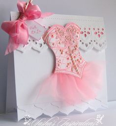 a card with a pink ballet outfit on it