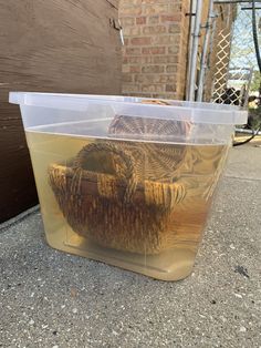 a plastic container with some baskets in it sitting on the ground next to a door