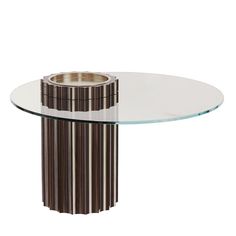 a glass and metal table with a circular base on the top, in front of a white background