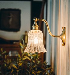 a wall light with a glass shade on it