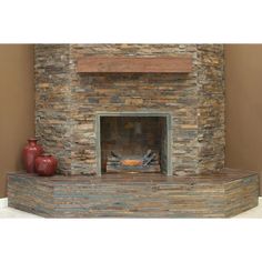 a stone fireplace with two vases on the mantle