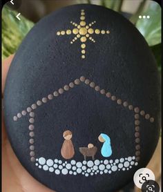 a hand painted rock with a nativity scene on it