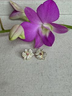 🌸 Orchidique's Limited Edition Dendrobium Orchid Earrings: 🌸 Key Features: Size: 15mm - Perfect for everyday elegance. Material: Luxurious S925 sterling silver - Durable and hypoallergenic. Radiant 14K gold plating - Adds warmth and a touch of opulence. Genuine white and red zircon - Captures the timeless beauty of a blooming dendrobium orchid. Design: Unique, one-of-a-kind floral dendrobium orchid pattern - Inspired by our family's first blooming Dendrobium orchid 30 years ago and lovingly ha Anniversary Flower Shaped Clip-on Earrings, Anniversary Flower Clip-on Earrings, Anniversary Clip-on Flower Earrings, Elegant Orchid Flower Earrings, Flower Shaped Clip-on Earrings For Anniversary, Orchid Flower-shaped Earrings For Gift, Yellow Gold Flower Clip-on Earrings As Gift, Yellow Gold Flower Clip-on Earrings For Gift, Flower Shaped Clip-on Earrings For Gift