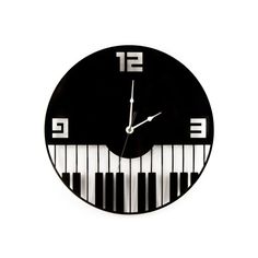 a black and white wall clock with piano keys on it's face is shown