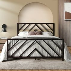 a large bed sitting on top of a wooden floor next to a wall mounted clock