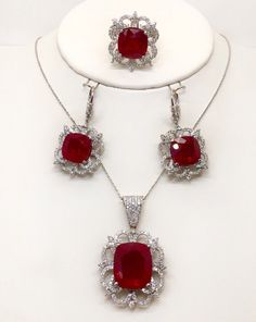 "Gorgeous and stunning set of ring, earrings, pendant and linked chain 18k solid white gold,diamond and cushion cut rubies. Total weight : 43.4 grams Total ruby weight appx : 51.31 TCW, lab created. Total diamond weight: 4.05 TCW Diamond clarity: VS1-2 (loupe clean) Diamond color: F (colorless) Pendant size appx : 40*25 mm, with the bail Earrings size appx : 40×20 mm ( longest to widest point ) Type of earrings fastening : Lever back Ring width on the top: 25 mm Chain length: 18\" Chain thicknes Cushion Cut Ruby Jewelry Gift, Cushion Cut Ruby Jewelry For Gift, Cushion Cut Ruby Jewelry As Gift, Fine Jewelry Ruby With Diamond Cut, Luxury Ruby Jewelry With Polished Finish, Diamond White Ruby Gemstone Jewelry, Diamond White Ruby Fine Jewelry, Luxury Polished Ruby Jewelry, Fine Jewelry Sets In White Gold For Formal Occasions