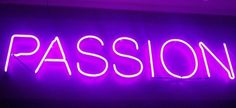 a neon sign that says passion in white letters on a dark wall with purple lighting