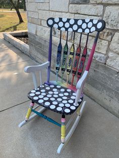 a colorful rocking chair made out of crayons