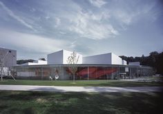 the building is designed to look like it has a curved roof and glass walls on top