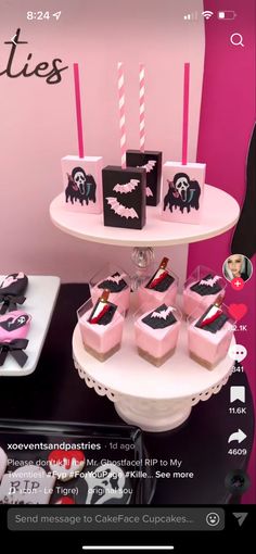 pink and black dessert table with cupcakes on it