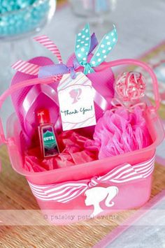 a pink basket filled with items on top of a table