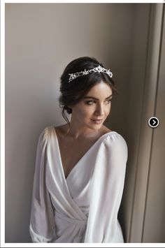 a woman in a white dress wearing a headband