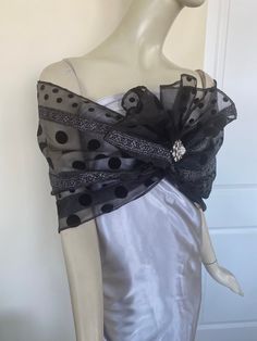 Elegant women's black organdy scarf with flocking. Silver accent. A sparkly accessory for special occasions. Drape on the neck as a traditional tie scarf or wrap around the shoulders as an elegant shawl. Semi sheer. Dry clean. ** Brooch not included. Elegant Black Scarves For Wedding, Black Wedding Shawl Scarf, Party Scarves In Organza, Elegant Organza Scarves For Party, Elegant Party Shawl Scarf, Printed Beach Dresses, Sparkly Accessories, Elegant Shawl, Formal Tops