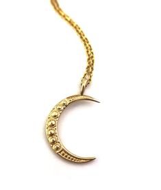 Our double sided Crescent Moon pendant is carved from a magnificent button from the 1880s. How lovely to think that this button, once a story of tight corsets is now a story of bold women like us. Unbuttoned and unbound. A perfect stand-alone statement piece or addition to your layering collection. 7/8" tall hand cast in 10k or 14k solid yellow gold this listing is for the pendant only. chain sold separately. Please note that our 14k gold items are custom made for you. Please allow 4-6 weeks if Antique Round Necklace With Moon Charm, Vintage Brass Jewelry With Moon Charm, Vintage Moon Phase Round Pendant Jewelry, Gold Moon Shaped Jewelry For Formal Occasions, Antique Moon Phase Jewelry Gift, Antique Carved Yellow Gold Necklaces, Formal Gold Moon-shaped Jewelry, Formal Gold Moon Shaped Jewelry, Victorian Crescent Wedding Jewelry