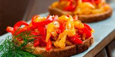 two pieces of bread topped with colorful toppings