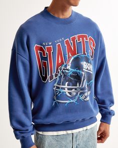 Show your team spirit in style with the Men's New York Giants Graphic Crew Sweatshirt from Abercrombie & Fitch. This piece combines comfort with fan pride, making it a must-have for any Giants supporter.

- Size: Small
- Color: Blue
- Material: SoftAF fleece fabric
- Gender: Male
- Age Group: Adult
- Features: Oversized-fit silhouette, New York Giants graphic on chest, crew neckline, banded hem and cuffs

Perfect for game day or casual wear, this sweatshirt ensures you stay cozy while cheering o Blue Sweats For Streetwear During Sports Season, Throwback Logo Print Sweatshirt For Fall, Fall Throwback Logo Print Sweatshirt, Collegiate Graphic Print Crew Neck Sweats, Oversized Crew Neck Sweatshirt For Game Day, Game Day Crew Sweatshirt, Oversized Crew Sweatshirt For Game Day, Oversized Sweatshirt With Ribbed Cuffs For Game Day, Relaxed Fit Throwback Sweatshirt With Graphic Print