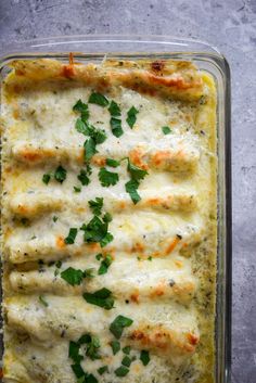 a casserole dish filled with meat and cheese covered in parmesan sauce