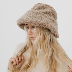 Meet our new Sage Sherpa Bucket Hat! This accessory is perfect for the fall/winter months, keeping you warm and stylish all season long. The Sage hat includes a thicker band around the head to add extra detail to the hat, and it's adjustable! Available in 2 colors including mocha and cream. Material: 100% Polyester Winter Beige Hat With Short Brim, Beige Short Brim Hat For Winter, Adjustable Wide Brim Cloche Hat For Winter, Beige Curved Brim Crochet Hat For Winter, Cozy Adjustable Hat For Cold Weather, Beige Hats For Cold Weather, Brimmed Winter Hats For Cold Weather, Warm Brimmed Bonnet For Fall, Adjustable Bucket Hat For Winter Outdoor Use