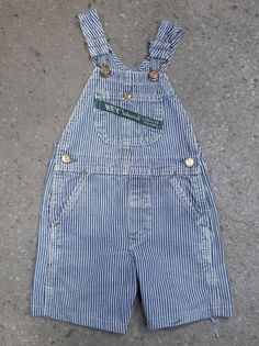 "Kid's vintage hickory stripe short overalls by Key \"Imperial\" Aristocrat of Overalls Made in U.S.A No Tag. Approximately sz. 3T Measurement taken laying flat: Waist: 11\" Front Rise: 7.5\" Length (from top of bib to hem of leg): 18.5\" Inseam: 5.5\" Features several discolouration marks, as pictured. International Shipping available" Vintage Blue Cotton Shortalls, Blue Vintage Cotton Shortalls, Striped Cotton Overalls For Spring, Spring Striped Cotton Overalls, Vintage Fitted Shortalls For Spring, Vintage Blue Shortalls, Vintage Spring Overalls, Vintage Cotton Shortalls With Pockets, Vintage Cotton Shortalls For Spring