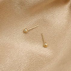 Simple gold ball studs, in the tiniest size. Minimalist and perfect for everyday, great for a second piercing. DETAILS 14kt gold filled 3mm ball matching earring backs included Simple Everyday Gold Piercings, Simple Gold Hypoallergenic Piercings, Tiny Classic Gold Piercings, Classic Tiny Gold Piercings, Tiny Simple Gold Cartilage Earrings, Classic Gold Nose Studs As Gift, Classic Gold Round Nose Studs, Everyday Tiny Gold Nose Studs, Gold Dainty Tiny Nose Studs