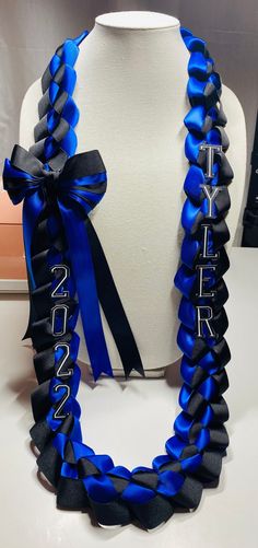 a blue and black ribbon necklace on a mannequin