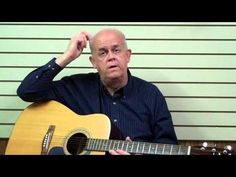 a man holding a guitar in front of his face