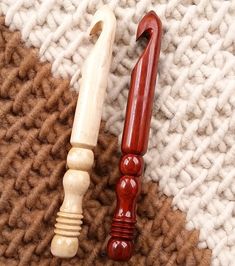 two wooden objects laying on top of a carpet