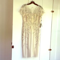 a white dress hanging on a door way