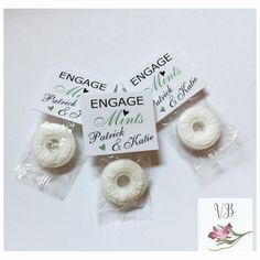 three small white donuts wrapped in plastic wrappers with the words engage minds printed on them