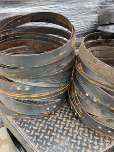 there are many old metal tubs stacked on top of each other