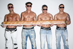 three shirtless men are holding a large long piece of bread in their hands and wearing sunglasses