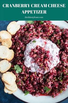 cranberry cream cheese appetizer on a plate with crackers and bread