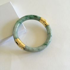 Description: 14k Yellow Gold Natural Round Jade Bangle Bracelet Item No.: B120 Metal Type: 14k Metal Color: Yellow Gold Type Of Stone: Natural Jade. Color: Mottded Green. Untreated. Measurement: Inner: 54 Mm. Outer: 72 Mm. Width: 8.5-10 Mm Approximate Weight: 45.04 Gram(S). New Without Tag No Trade! Luxury Green Bangle For Anniversary, Elegant Jade Bangle For Formal Occasions, Luxury Green Bracelets, Elegant Green Round Bangle, Elegant Yellow Gold Jade Bracelets, Elegant Yellow Gold Jade Bracelet, Luxury Gold Jade Bracelets, Luxury Green Gemstone Bangle, Elegant Jade Round Bangle