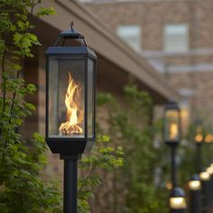 a lamp post with a fire burning in it