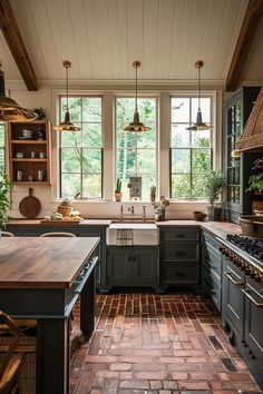 a kitchen with brick flooring and lots of counter space next to a stove top oven