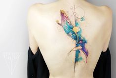 the back of a woman's body is covered in colorful ink and watercolors