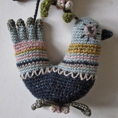 a knitted bird ornament hanging from a string