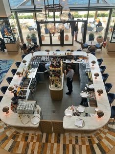 an overhead view of a restaurant with lots of tables and chairs in front of large windows