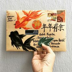 a person holding up a piece of paper with writing on it and an image of a bird