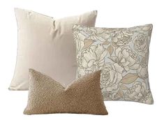 three pillows with different designs on them, one in gold and the other in white