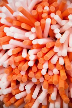 many orange and white toothbrushes arranged in a circle