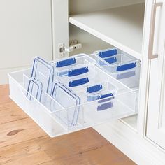 an organized drawer in the corner of a kitchen with several plastic drawers and dividers