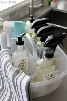 a bathroom sink filled with lots of different types of soaps and hand washes